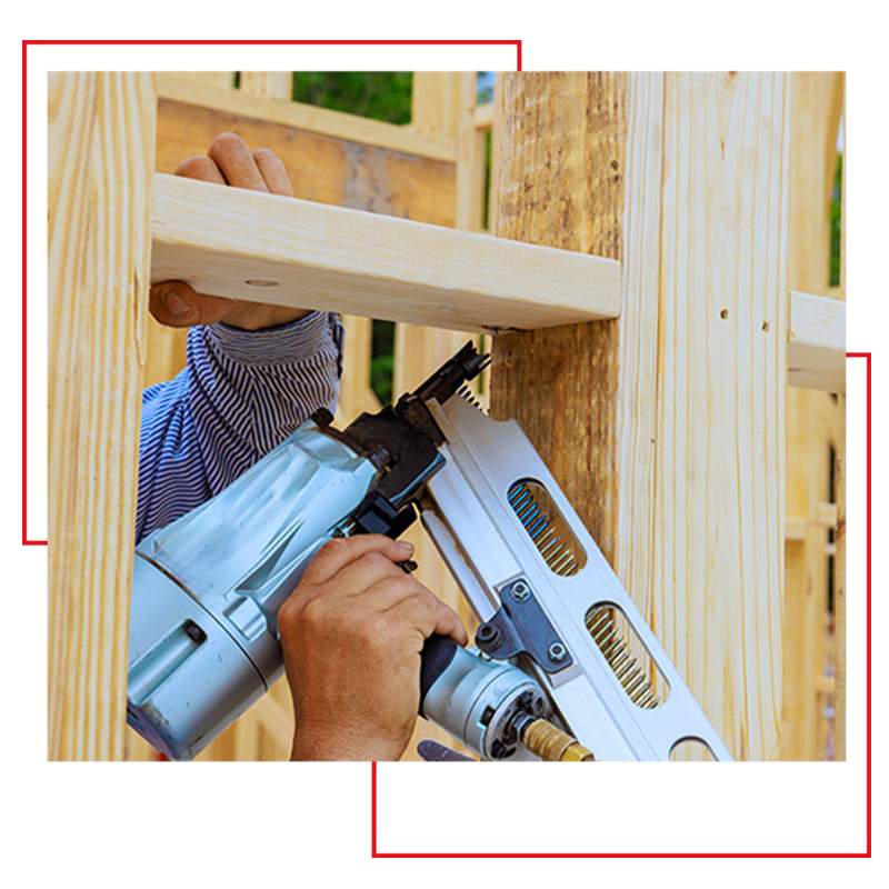 Worker with nail gun with red decorative squares behind it