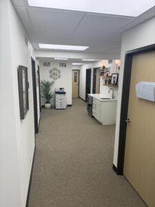 Modern commercial office hallway with custom finishes and employee kitchenette