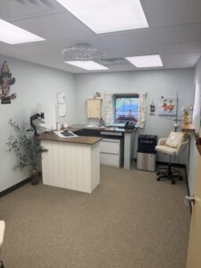 Custom office workspace with built-in desk, floating wood shelves, and modern cabinetry
